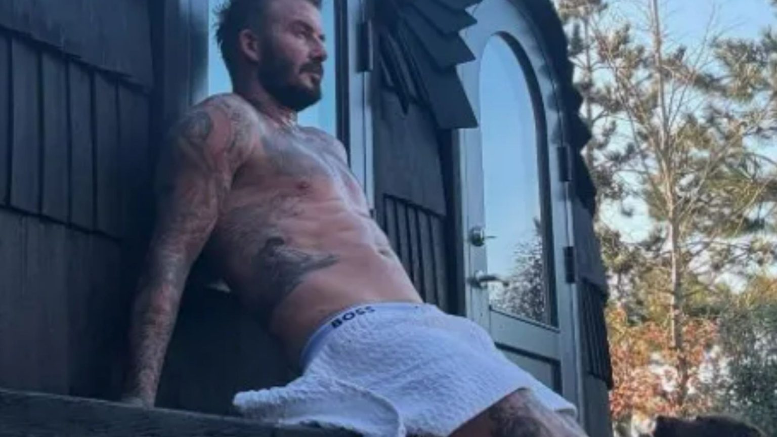 David Beckham drives fans wild with ‘self care Sunday’ snap as he poses in just a towel outside his home sauna