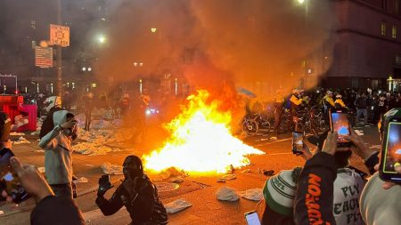 Carnage on streets as Philadelphia Eagles fans celebrate Super Bowl win by setting fires, climbing cop cars & brawling