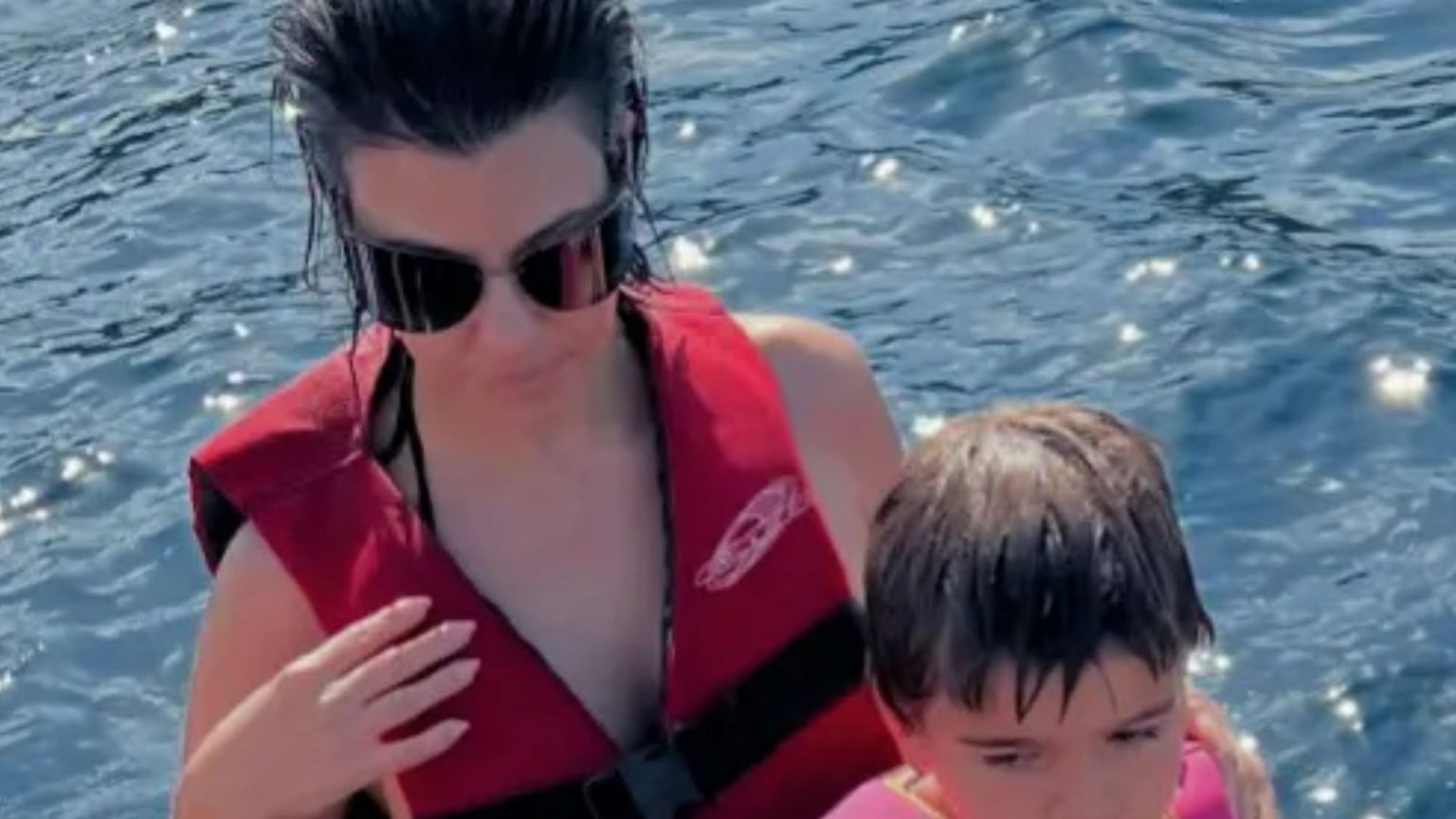 Kourtney Kardashian wows in a black thong bikini onboard luxury yacht in throwback to family holiday in Italy