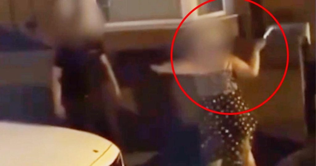 Woman caught on camera waving knife and yelling racist abuse at man on street