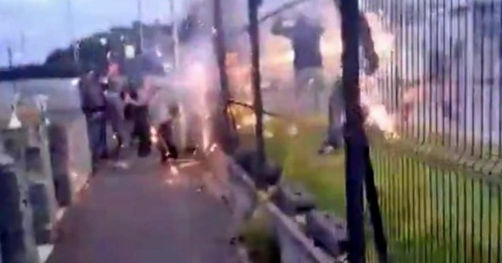 Masked hooligans shoot flares and chuck iron slabs in violent football clash