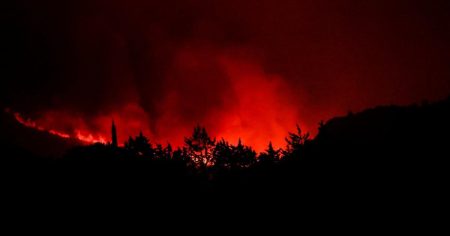 One person dies and hundreds flee after wildfires spread across France and Spain