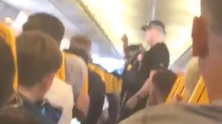 Moment cops boot Ryanair passenger off jet after they ‘tried to open emergency exit’ just after takeoff