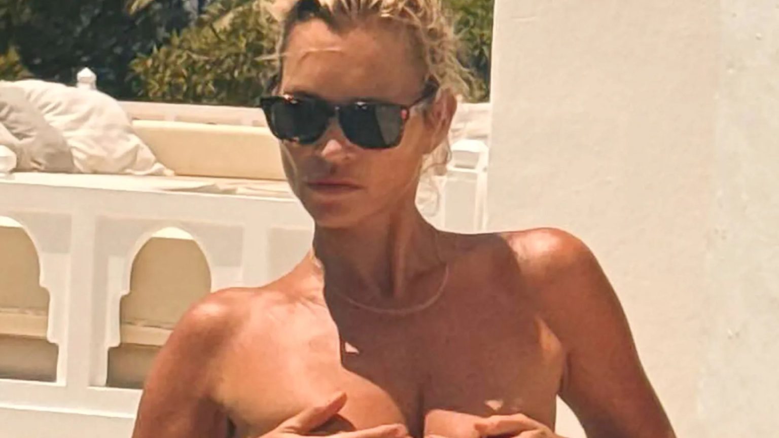 Supermodel legend Kate Moss, 51, stuns as she covers boobs while swimming topless on holiday in Ibiza