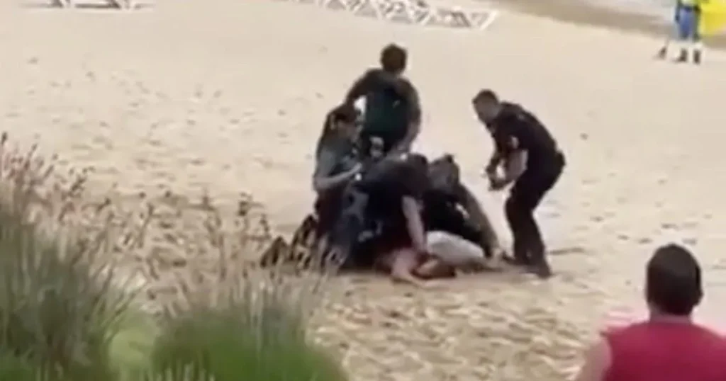 Tourist beaten by police after trying to shadowbox them naked