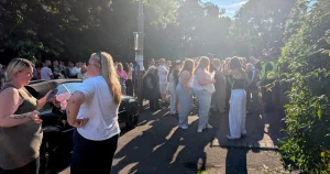 Crowd shouts ‘no peace for a beast’ outside flats where alleged rapist lives