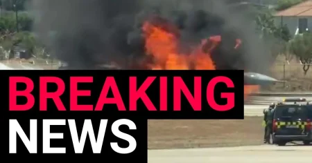 Fighter jet goes up in flames after crash landing at airport