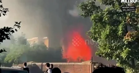 Huge fire seen for miles across London after blaze breaks out near homes