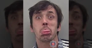Bully who stuck his tongue out for mugshot after strangling woman is jailed