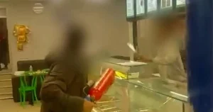 Fearless bystander takes on knifeman terrorising takeaway with fire extinguisher