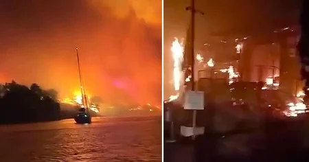 Holidaymakers run into sea as they watch resort go up in flames