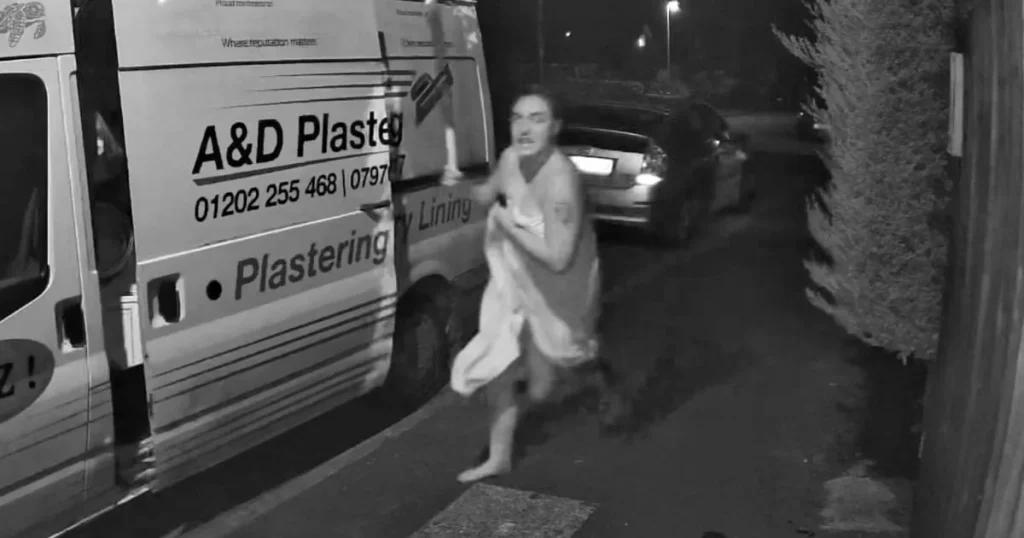 Moment woman wearing only bath towel armed with baseball bat chases off car thief