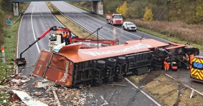 Lorry full of Warburtons bread sheds its load across carriageway